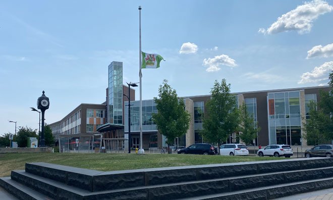 County flag flying at half-mast on community flagpole