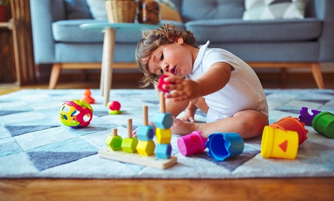 A baby playing with block toys
