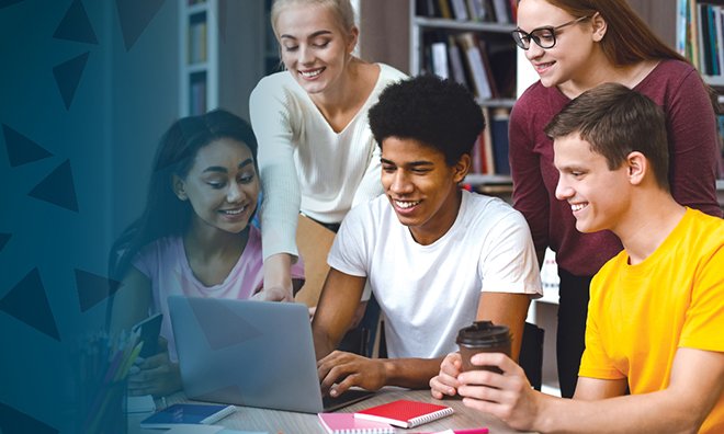 Five youth sitting around a computer smiling at the screen.