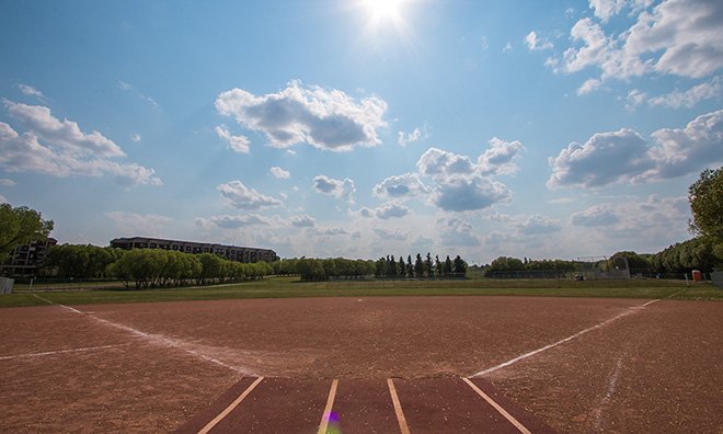 wide angle shot of large baseball diamond on a sunny, clear blue sky day