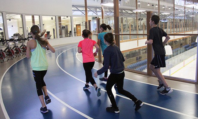 kids running on the indoor track