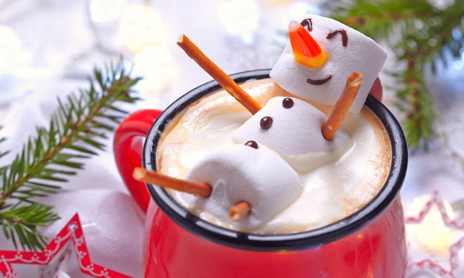 Marshmallow snowman floating in a cup of cocoa