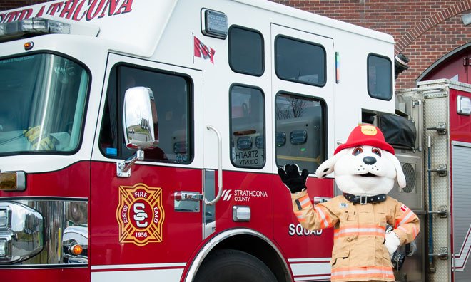 Sparky the fire dog in front of a fire truck