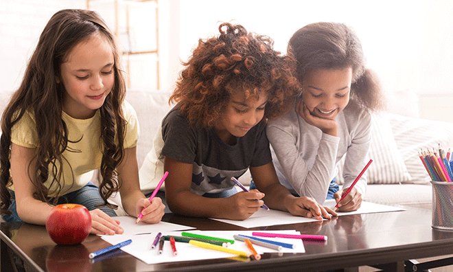 Image showing three students colouring at a table