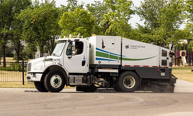 Street sweeper working on residential road