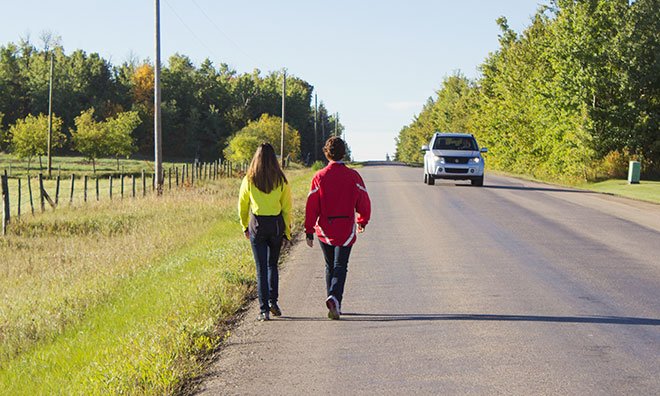Image of pedestrians walking on rural road
