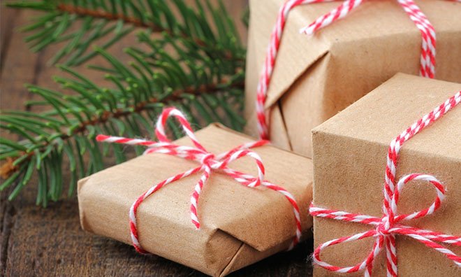 Image of presents wrapped with brown paper and tied with red and white string.