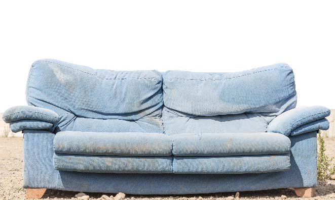 old and worn pale blue couch