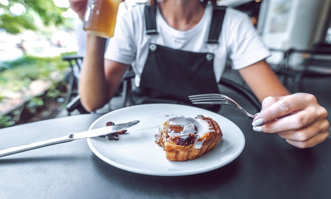 Cinnamon bun being eaten from a plate