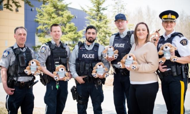RCMP and Enforcement Services Officers with Victim Services teddys and supervisor