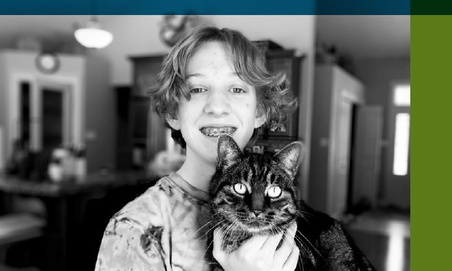 Black and white portrait of rural Strathcona County resident and Grade 8 student Camryn with her cat