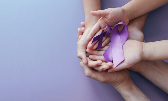 Family hands holding a purple ribbon