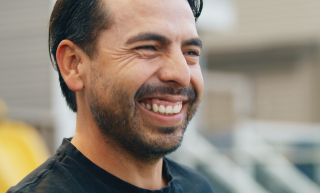 Image of a smiling man outdoors