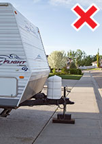 Recreational vehicle parked on the driveway but hanging over the sidewalk which is not allowed