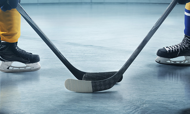 Skates and a hockey stick on the ice