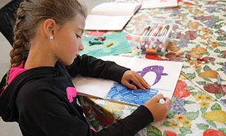 Girl drawing a penquin