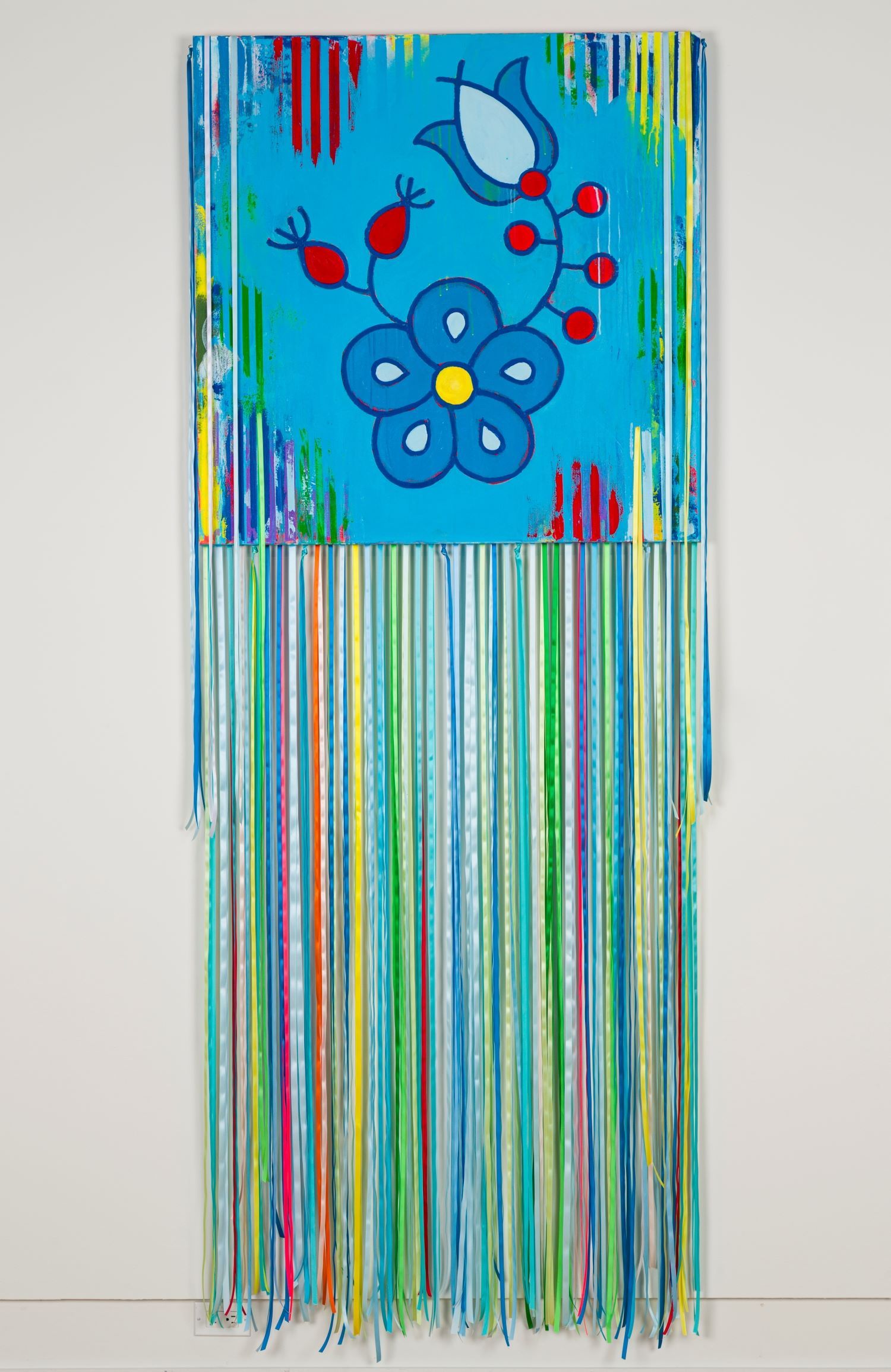 Painting of a flower on a blue background with vertical stripes. Long, multi-coloured ribbons hang from the bottom.