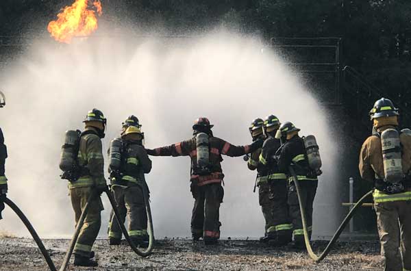 Firefighters in front of a fire