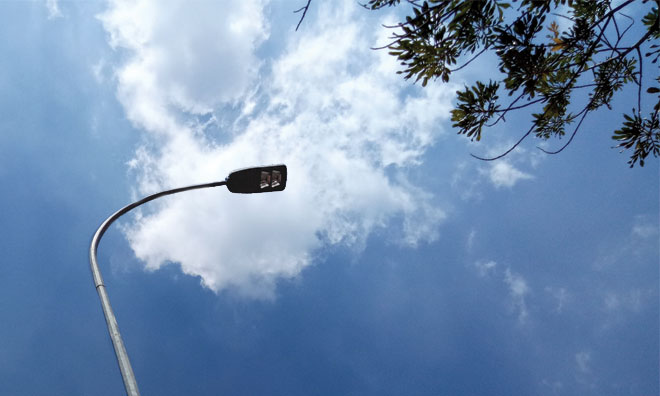 Street light against blue sky and clouds
