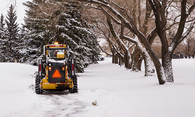 Equipment clearing snow from a County trail
