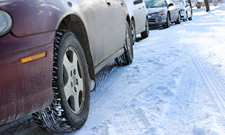 cars parked on the side of the road in winter