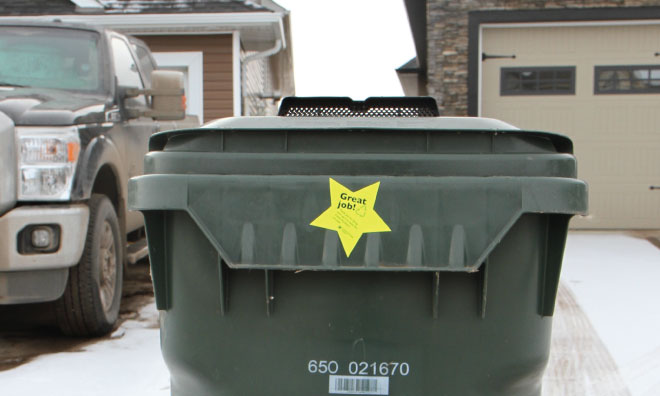 Image of an organics cart with a gold star sticker that says 'good job.'