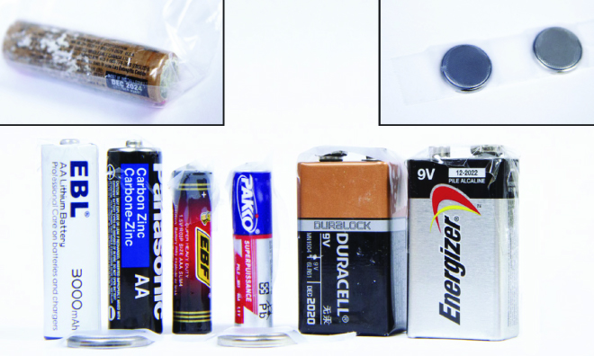 Image of different types of non-alkaline batteries, 9V, lithium batteries, corroded batteries and small button batteries.