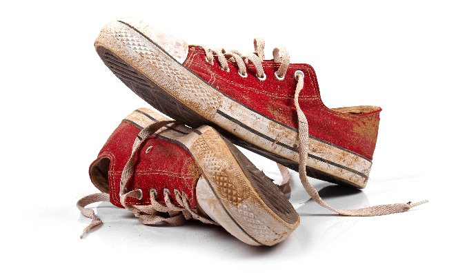 Pair of dirty red shoes.