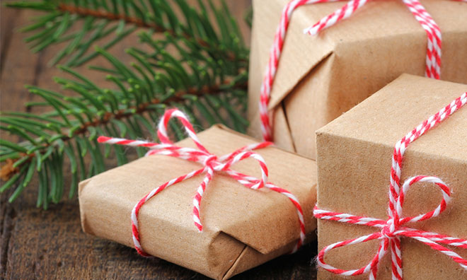 Image of presents wrapped with brown paper and tied with red and white string.